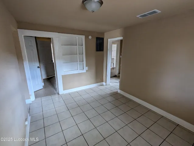 a view of an empty room and closet area