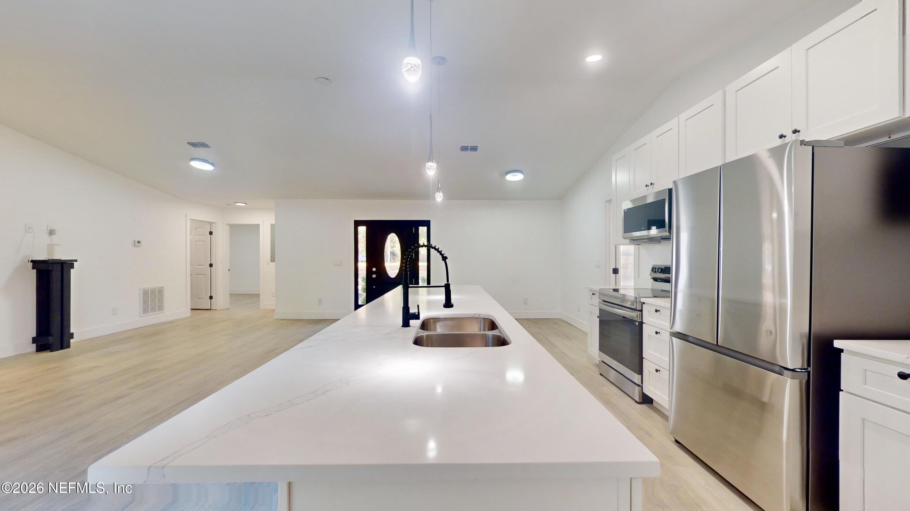 4774 Leopard Circle Middleburg, FL 32068 - Photo 15 of 50 a kitchen with stainless steel appliances a refrigerator and a stove