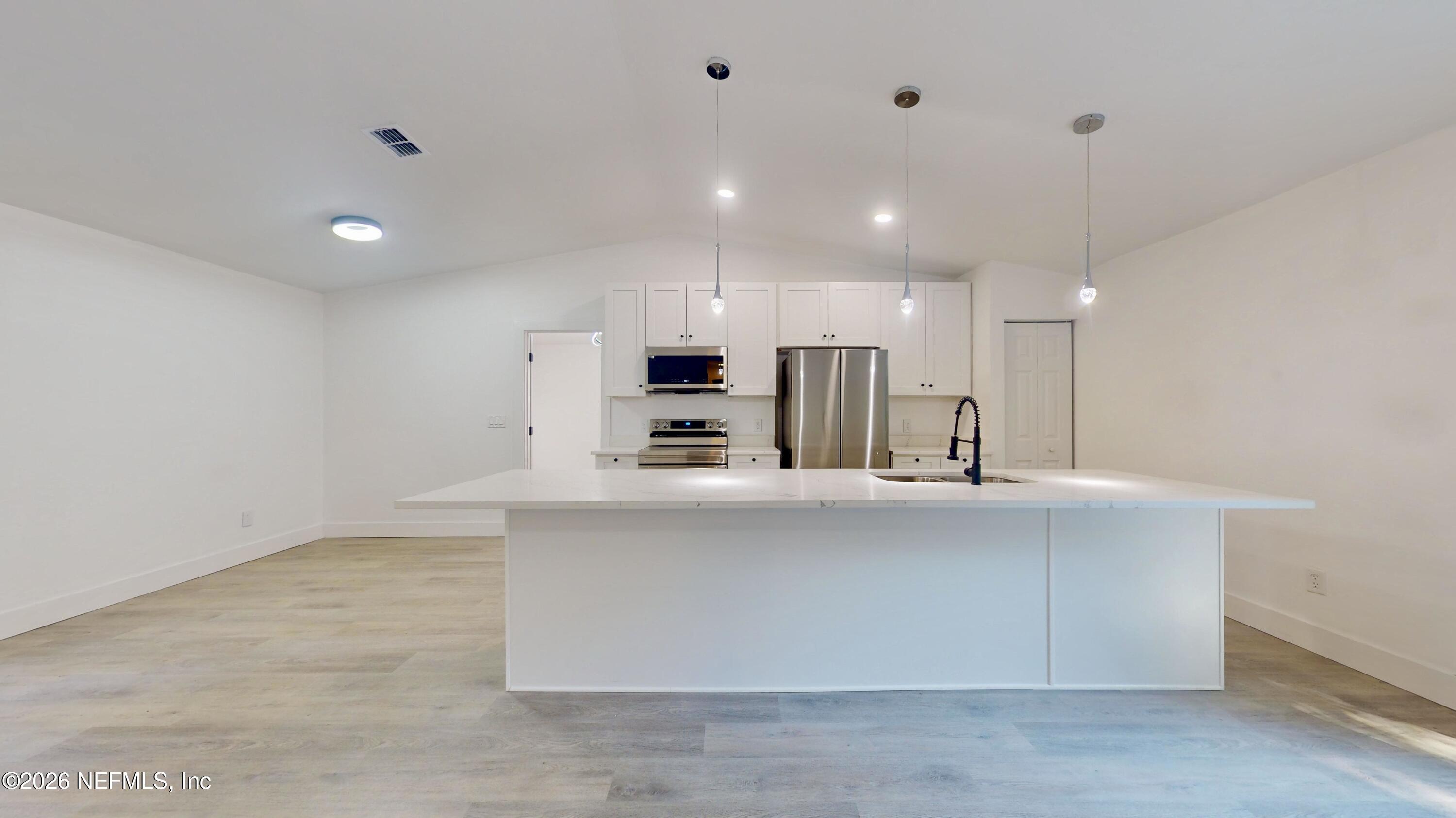 4774 Leopard Circle Middleburg, FL 32068 - Photo 21 of 50 a large kitchen with kitchen island a sink stainless steel appliances and cabinets