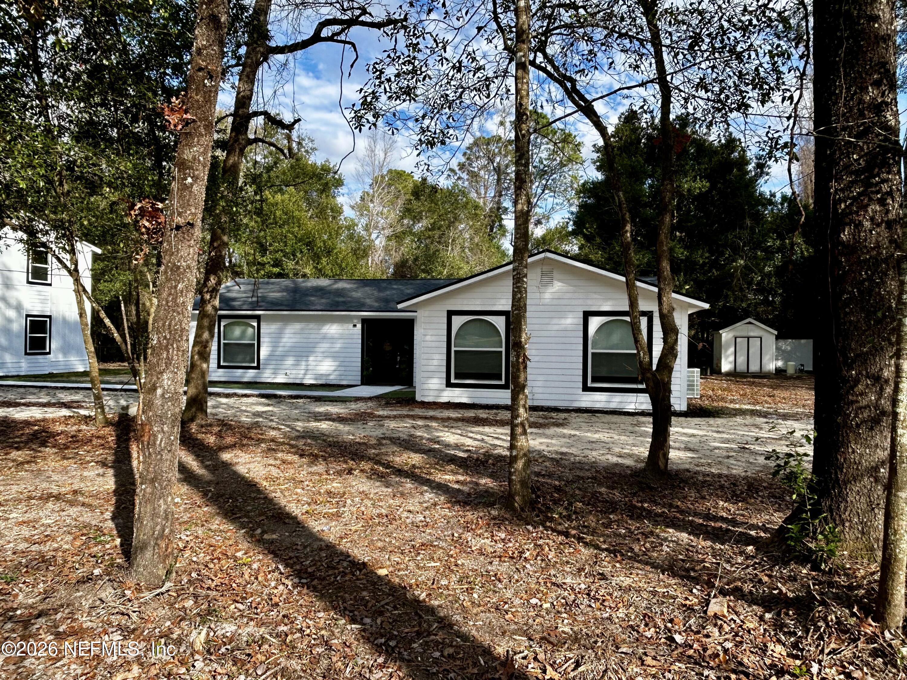 4774 Leopard Circle Middleburg, FL 32068 - Photo 8 of 50 a house with trees in the background