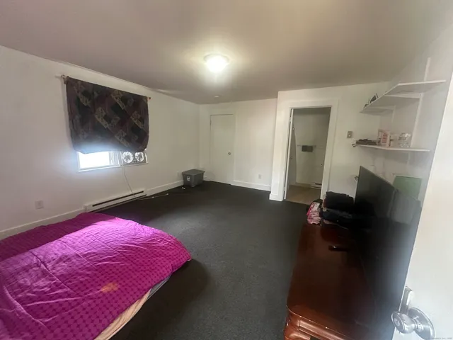 wooden floor with a rug and a window