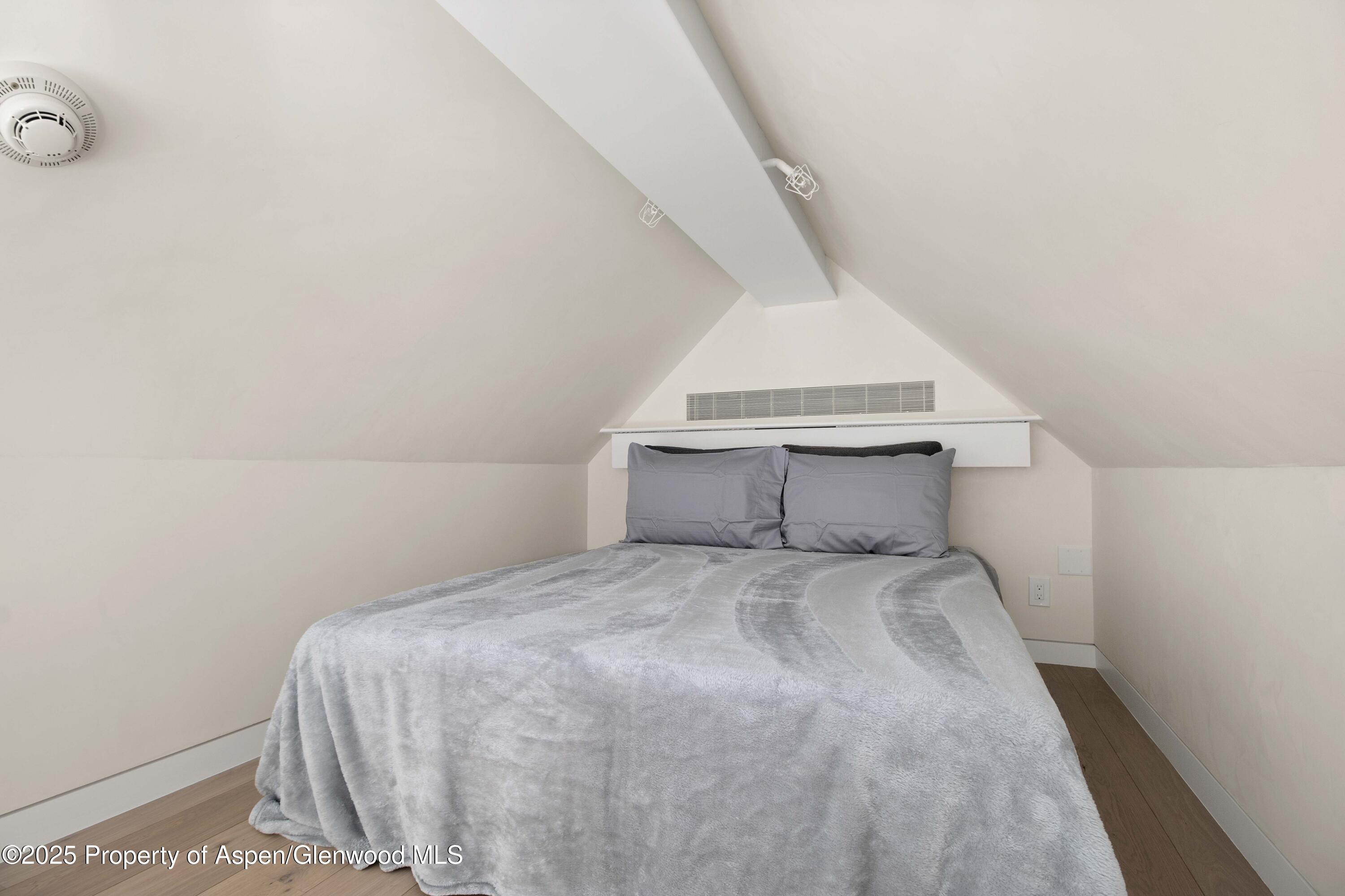 211 West Main Street, Unit 201 Aspen, CO 81611 - Photo 11 of 14 a bedroom with a bed and a window