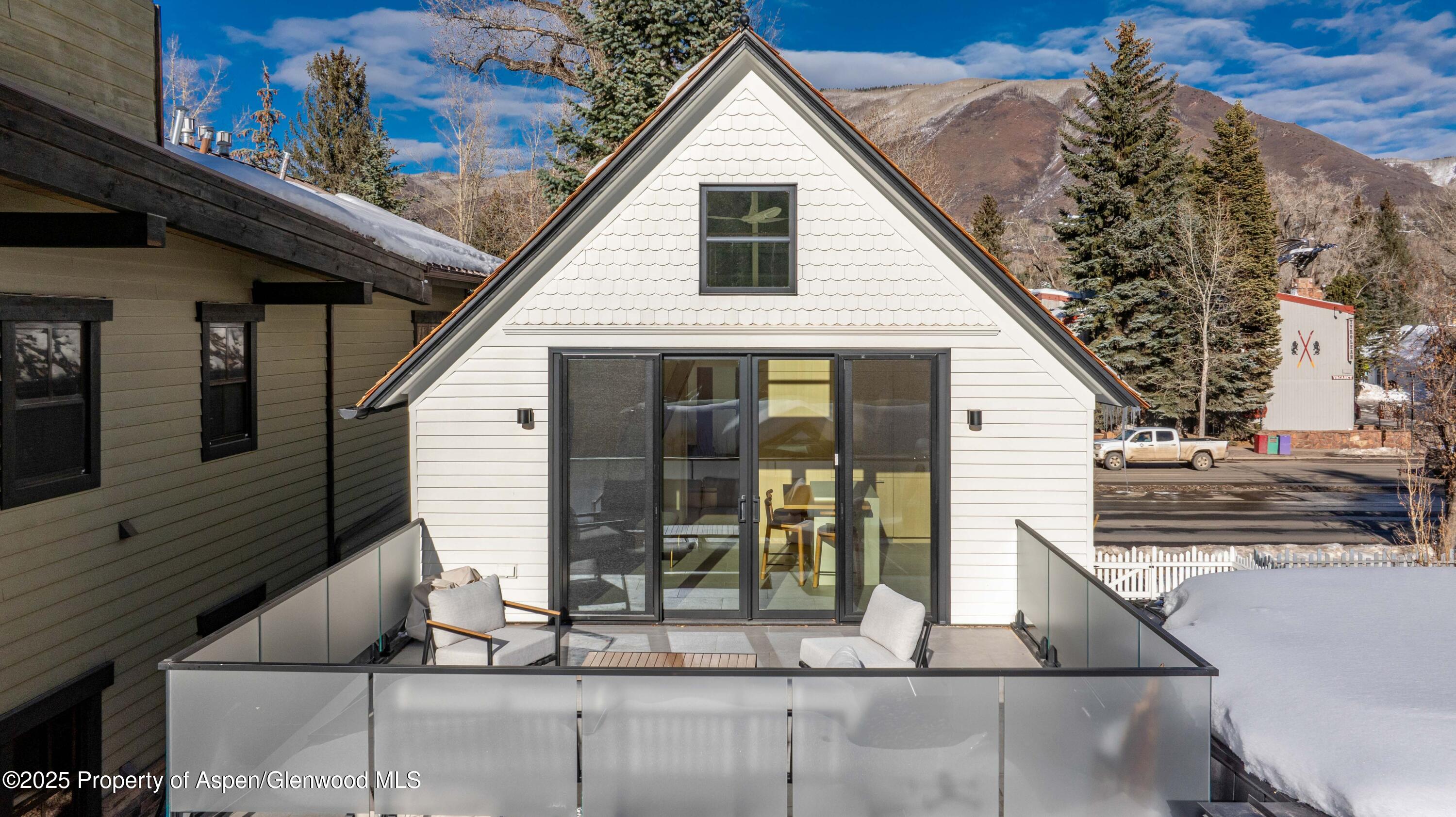 211 West Main Street, Unit 201 Aspen, CO 81611 - Photo 4 of 14 a view of a small house with roof deck front of house