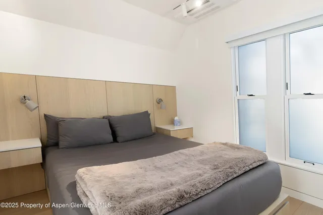 a bedroom with a large bed and a couch