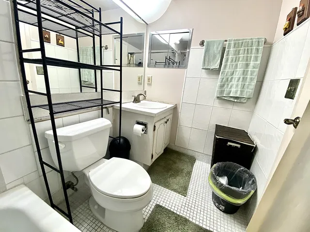 a bathroom with a toilet a sink and mirror