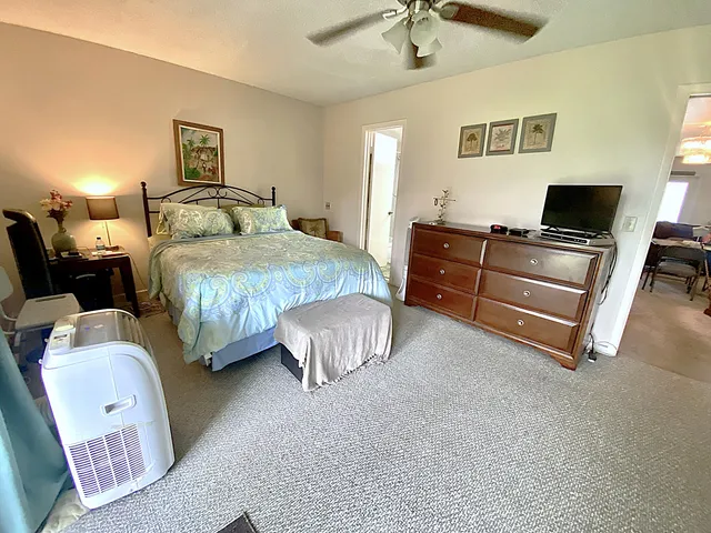 a view of a room with a large window and sitting area