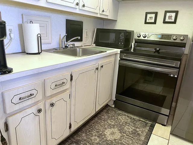 a kitchen with stainless steel appliances a sink and cabinets