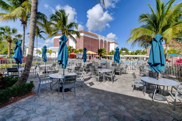 a view of a patio with table and chairs under an umbrella