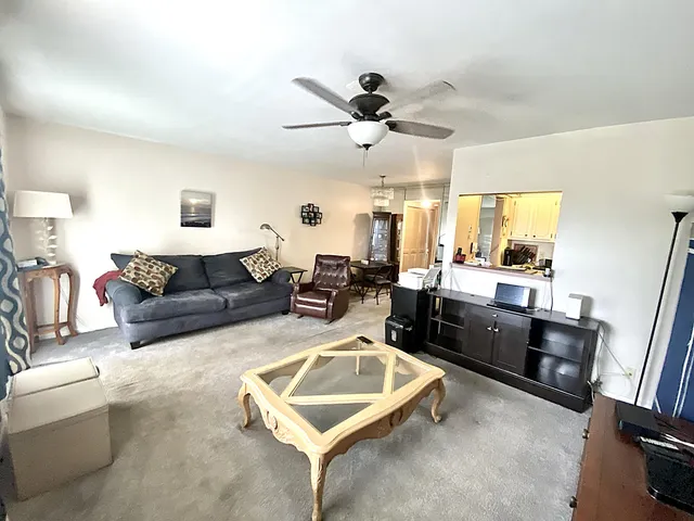 a living room with furniture and chandelier