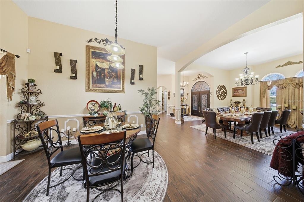 13429 Montevista Road Clermont, FL 34711 - Photo 17 of 89 a view of a dining room and livingroom with furniture wooden floor a chandelier
