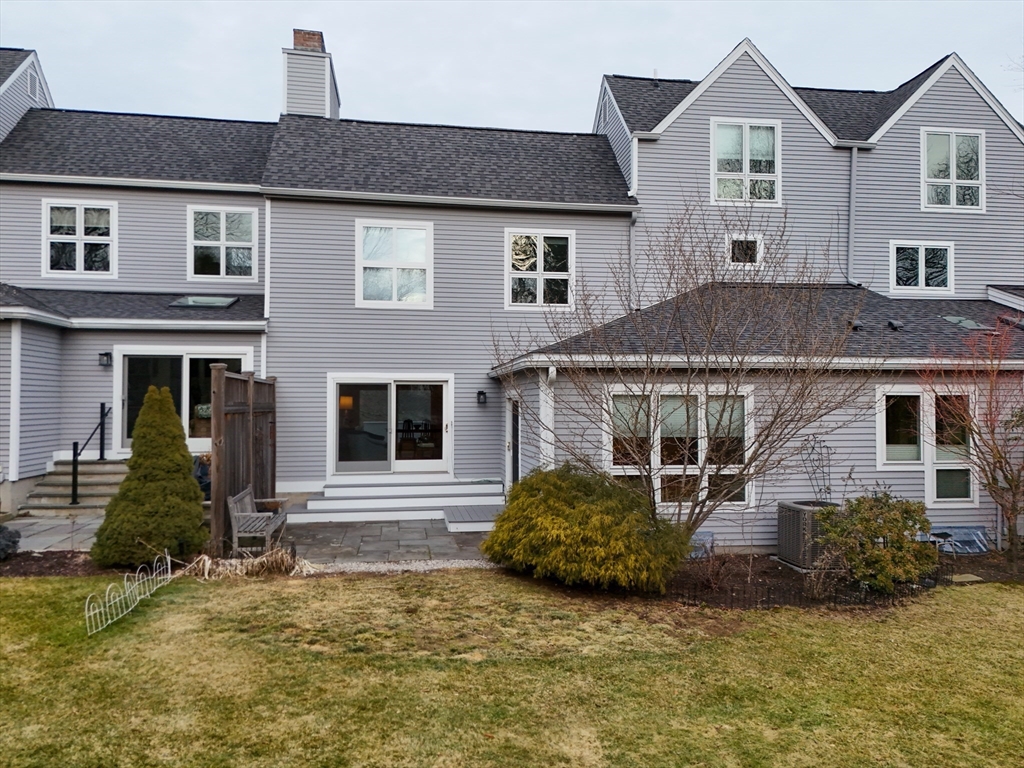 6 Hopewell Farm Road, Unit 6 Natick, MA 01760 - Photo 3 of 18 a front view of a house with a yard