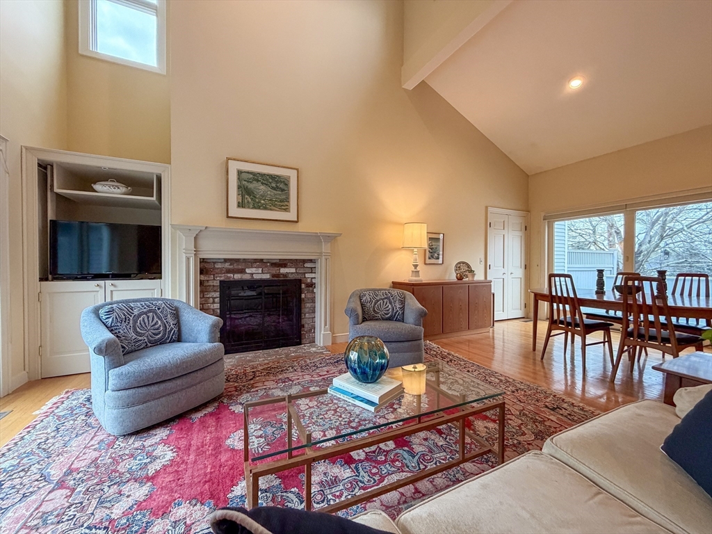 6 Hopewell Farm Road, Unit 6 Natick, MA 01760 - Photo 6 of 18 a living room with furniture a table and a fireplace