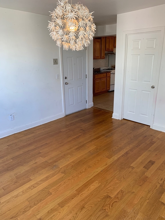 104 Beacon Street, Unit 7 Chelsea, MA 02150 - Photo 4 of 6 a view of a room with wooden floor and a window