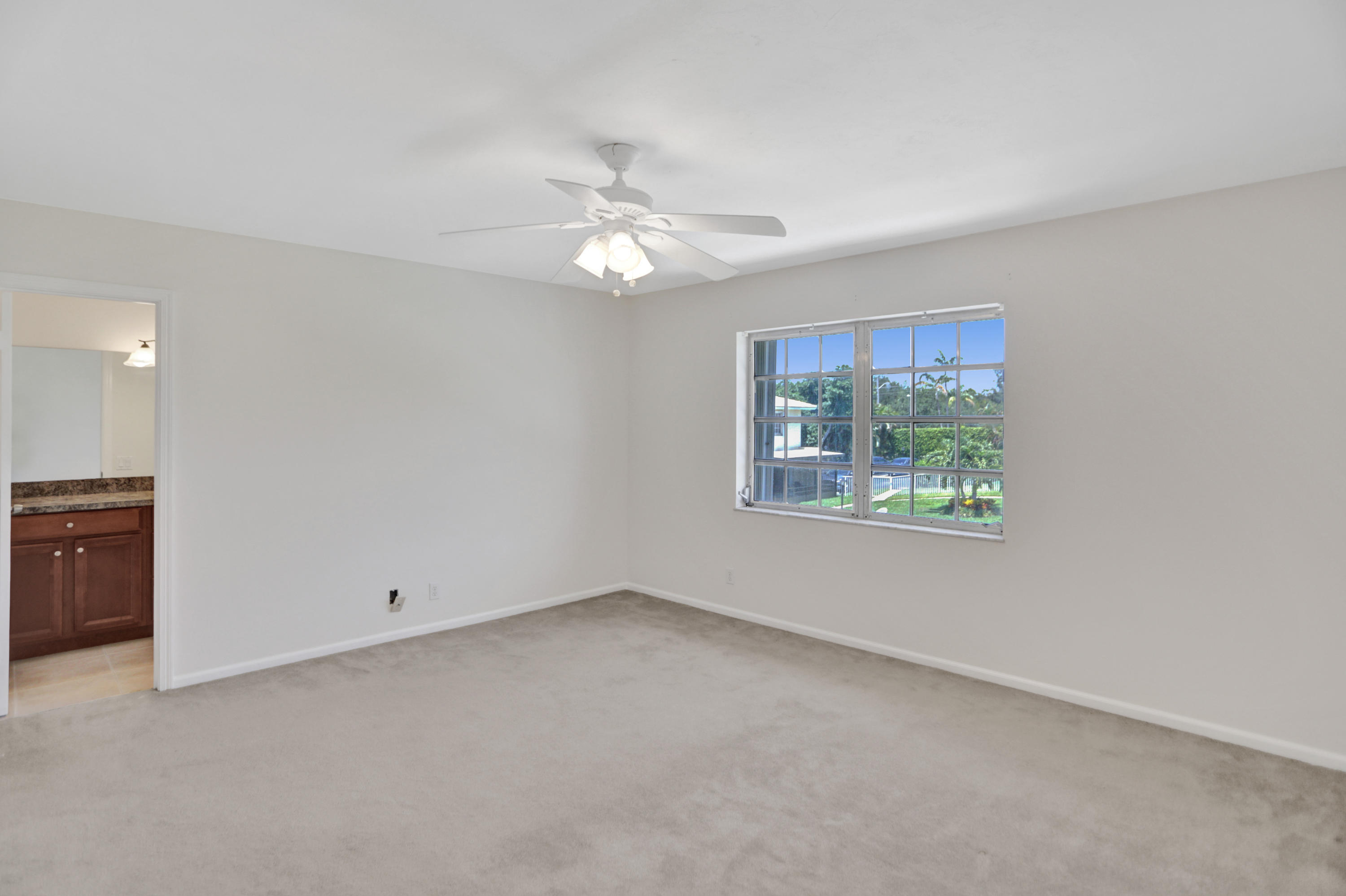 90 Southwest 5th Avenue, Unit 10 Boca Raton, FL 33432 - Photo 26 of 53 an empty room with windows and fan