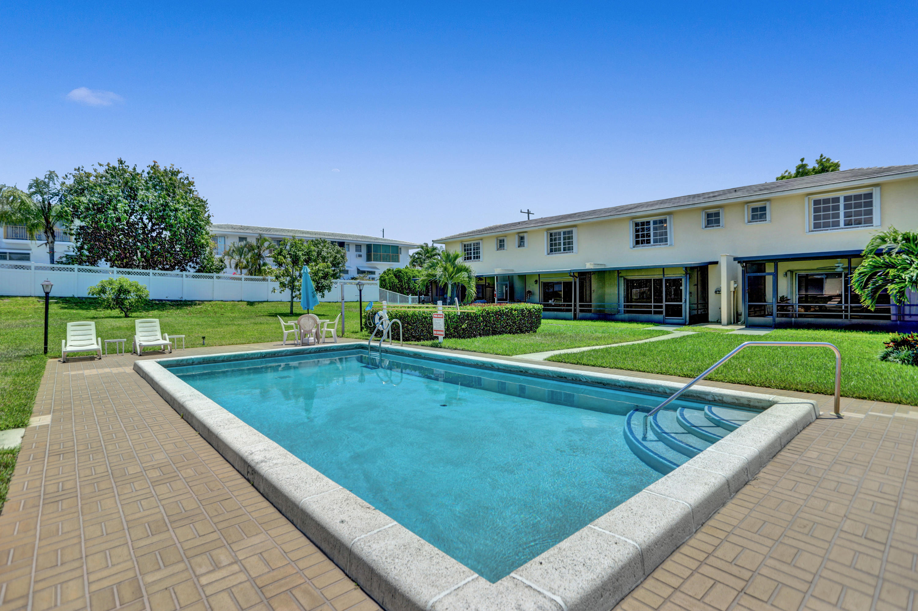 90 Southwest 5th Avenue, Unit 10 Boca Raton, FL 33432 - Photo 43 of 53 a view of swimming pool with a yard