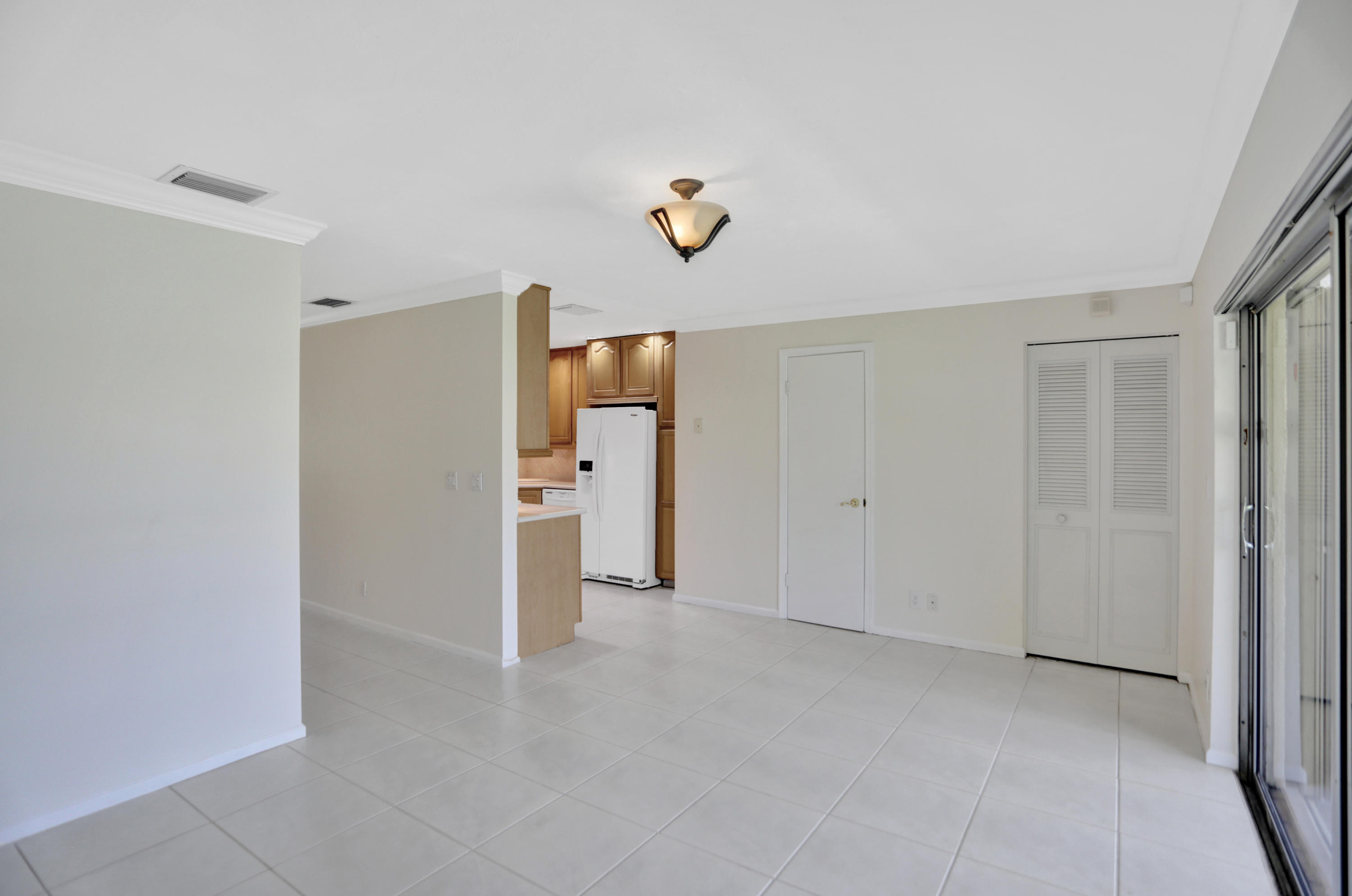90 Southwest 5th Avenue, Unit 10 Boca Raton, FL 33432 - Photo 8 of 53 a view of a closet area with ceiling fan