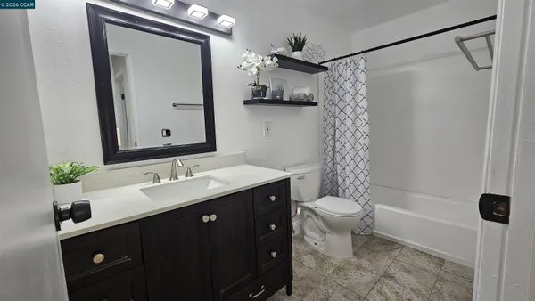 a bathroom with a double vanity sink toilet and shower