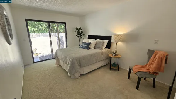 a bedroom with a bed chair and window