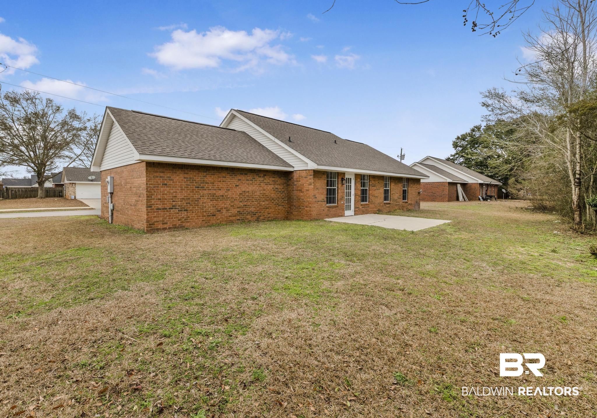 16330 Absalom Street Foley, AL 36535 - Photo 11 of 42 Back of property with a yard and a patio area