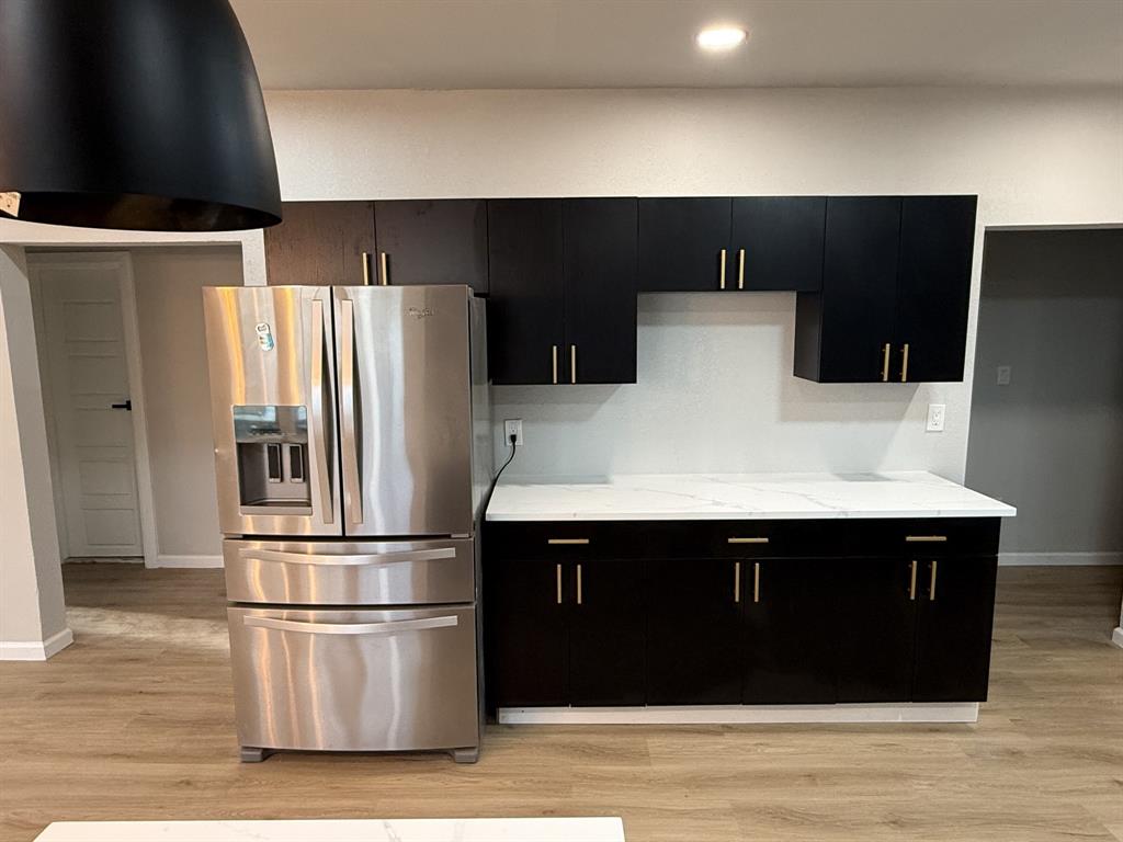 758 Bethpage Avenue Dallas, TX 75217 - Photo 5 of 20 a kitchen with a refrigerator and a stove
