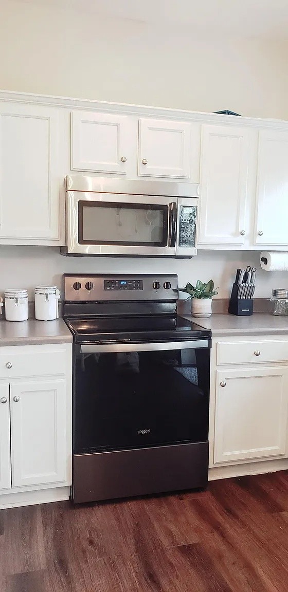 105 4th Avenue, Unit 106 Murfreesboro, TN 37130 - Photo 2 of 6 a kitchen with stainless steel appliances granite countertop a stove microwave and sink