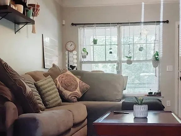 a living room with furniture and large window