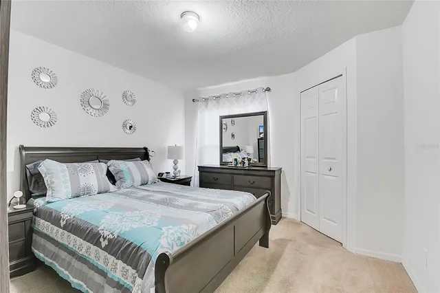 a bedroom with a bed and a dresser