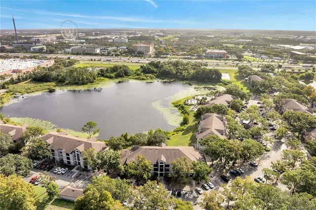 an aerial view of lake residential house with outdoor space and trees around