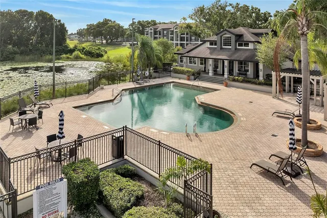 a view of a house with pool and sitting area