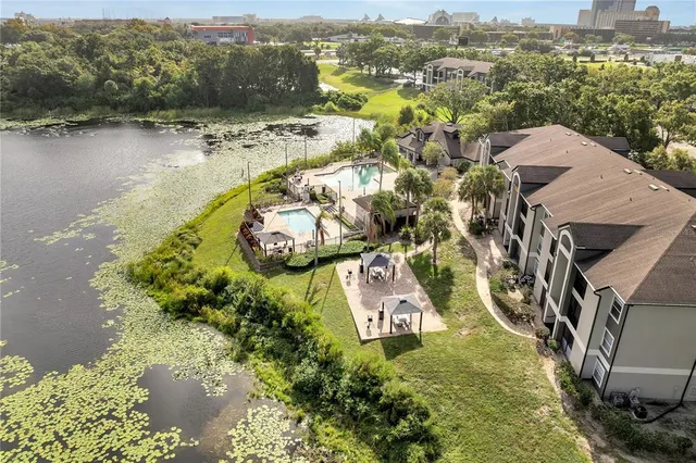 an aerial view of residential houses with outdoor space and river