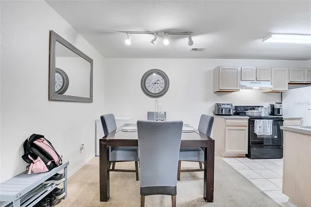 a view of kitchen with cabinets table and chairs