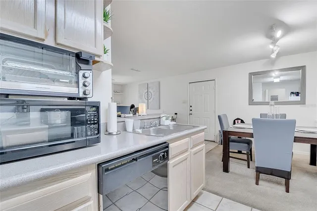 a kitchen with a sink cabinets and wooden floor