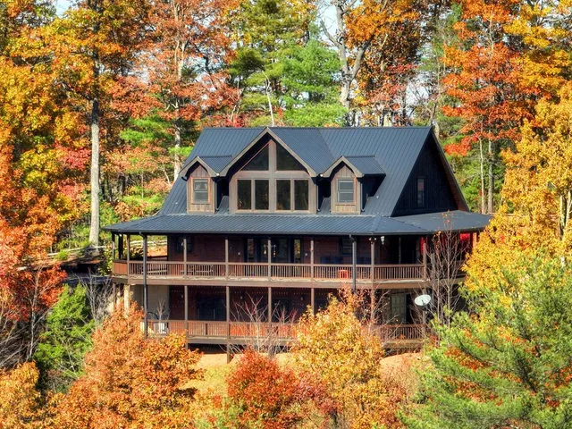 a view of a large house with a large window and wooden fence