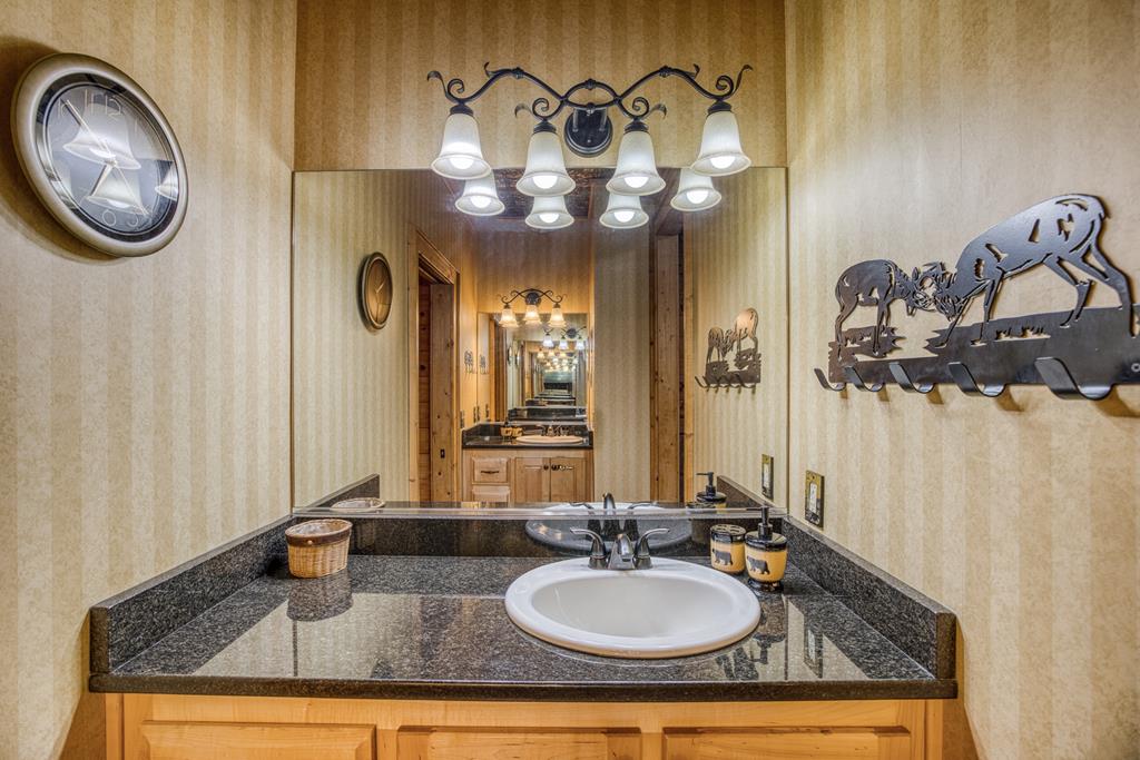 671 Stover Knob Trail Cherry Log, GA 30522 - Photo 30 of 89 a bathroom with a granite countertop sink and a mirror