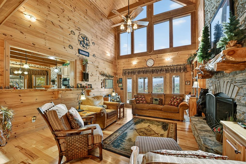 671 Stover Knob Trail Cherry Log, GA 30522 - Photo 10 of 89 a view of a patio with couches chairs and a floor to ceiling window