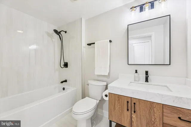 a living room with furniture and large windows
