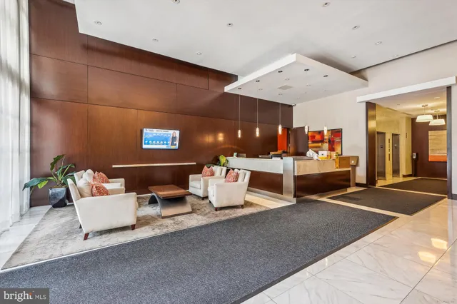 a view of a patio with couches table and chairs and potted plants