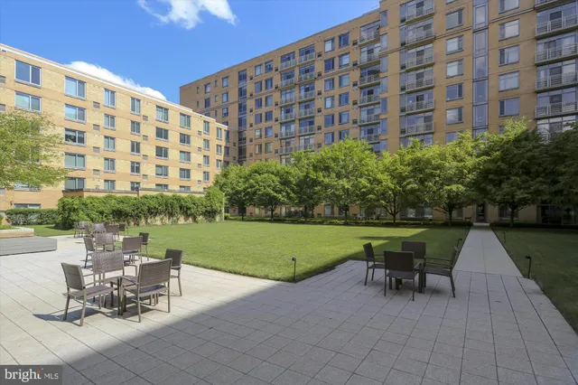 a living room with furniture and a book shelf