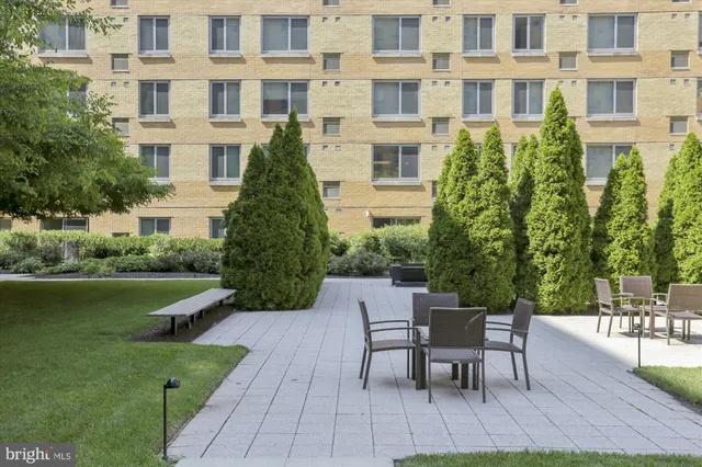 a living room with lots of furniture and a large window