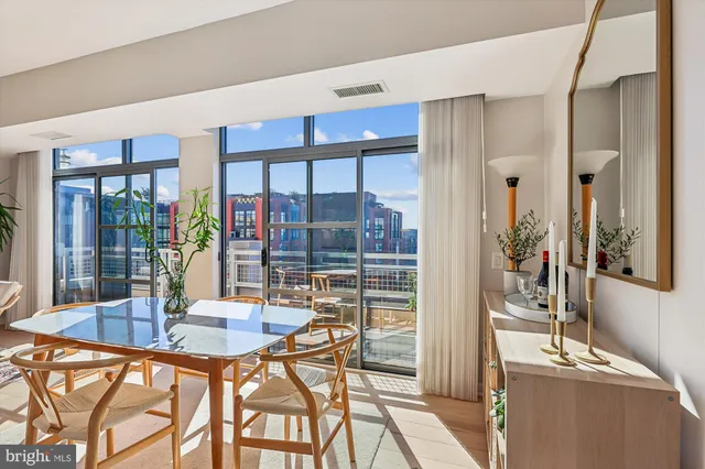 a kitchen with granite countertop a refrigerator a stove a sink dishwasher and white cabinets with wooden floor