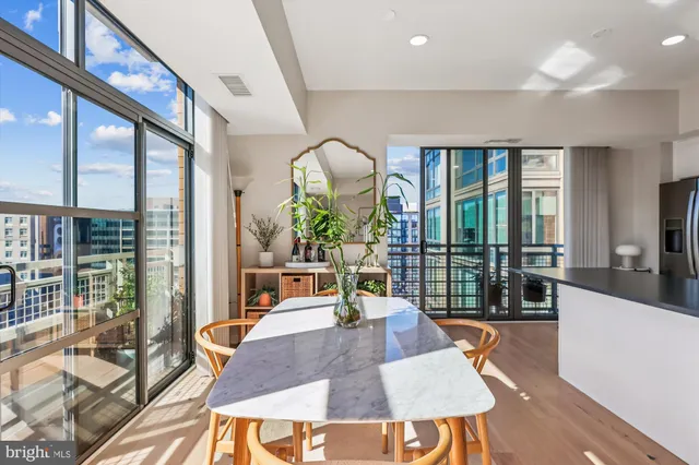 a kitchen with granite countertop white cabinets and stainless steel appliances