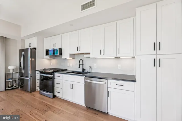 a kitchen with granite countertop a stove and a sink