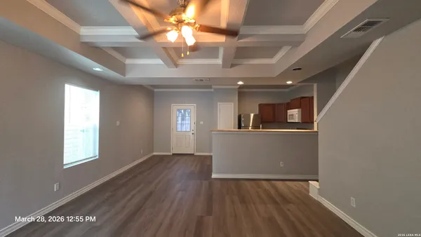 an empty room with closet and wooden door
