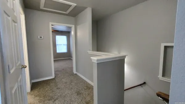 an empty room with a empty space and a ceiling fan