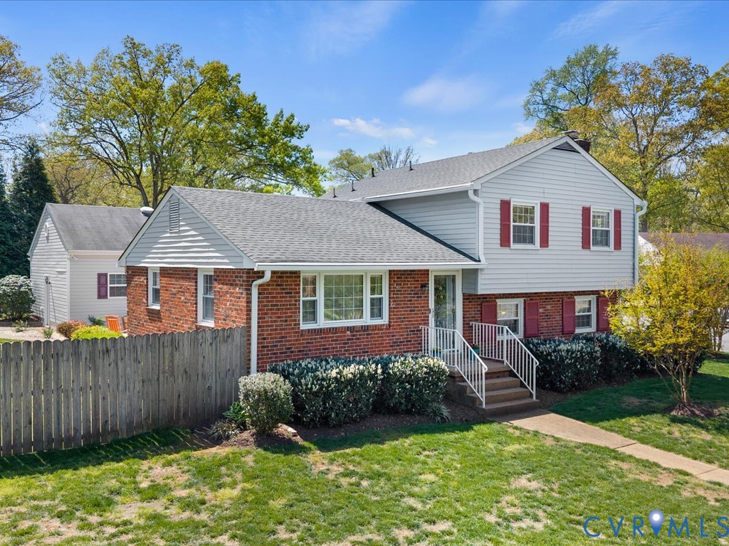 1455 Robindale Road Richmond, VA 23235 - Photo 3 of 29 a front view of a house with a yard and garage