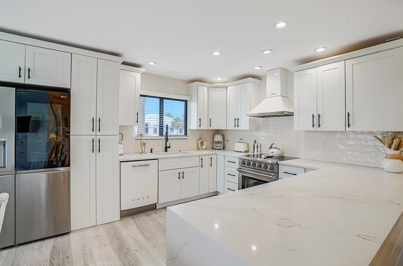 a kitchen with white cabinets and stainless steel appliances