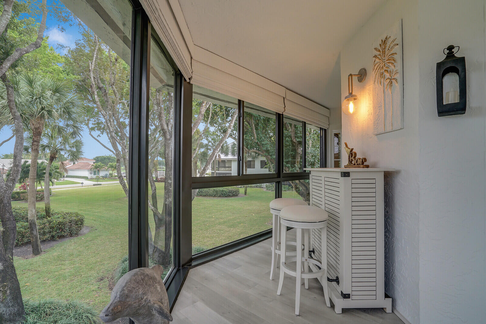 7527 Glendevon Lane, Unit 805 Delray Beach, FL 33446 - Photo 15 of 52 a view of a porch with furniture and a yard