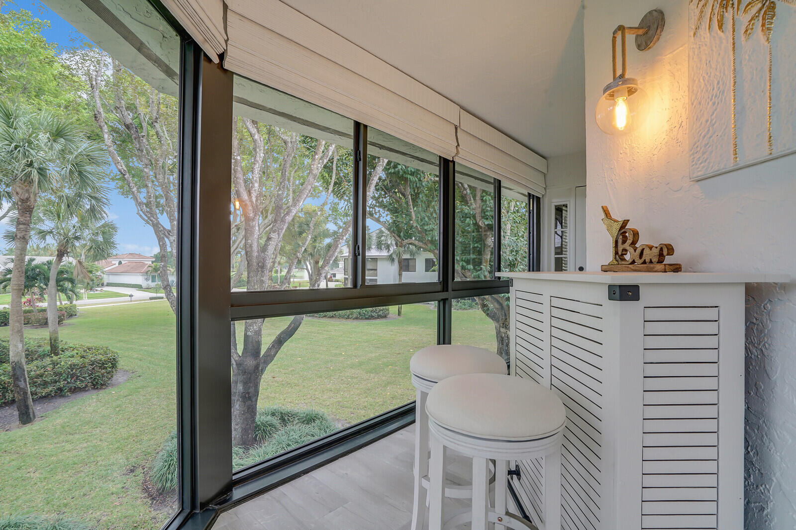 7527 Glendevon Lane, Unit 805 Delray Beach, FL 33446 - Photo 19 of 52 a room with a large window and chairs