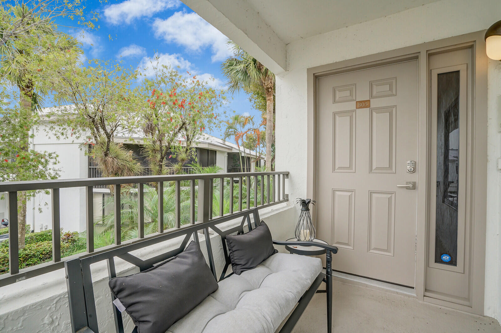 7527 Glendevon Lane, Unit 805 Delray Beach, FL 33446 - Photo 4 of 52 a balcony with furniture and a potted plant