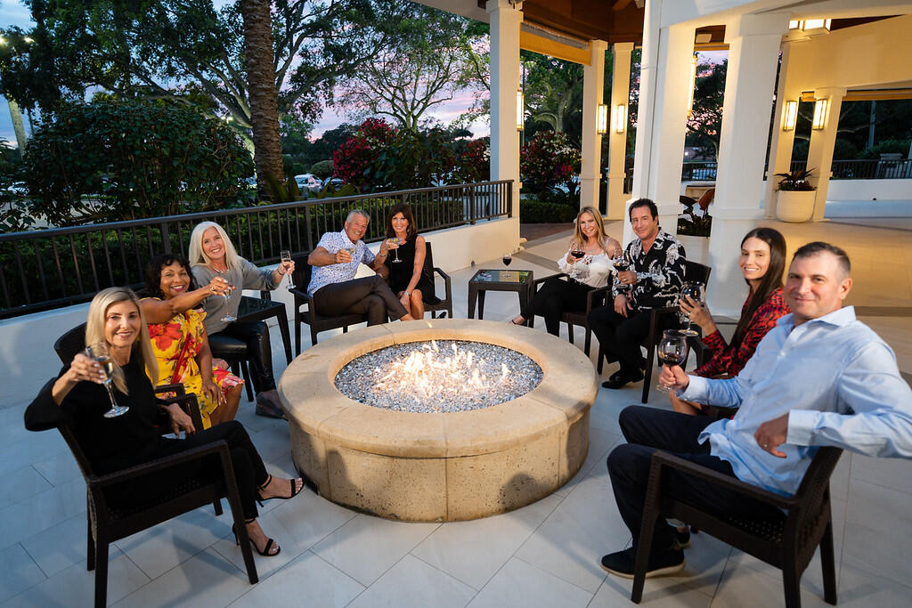 7527 Glendevon Lane, Unit 805 Delray Beach, FL 33446 - Photo 48 of 52 a view of a chairs and tables in the patio in front of a house